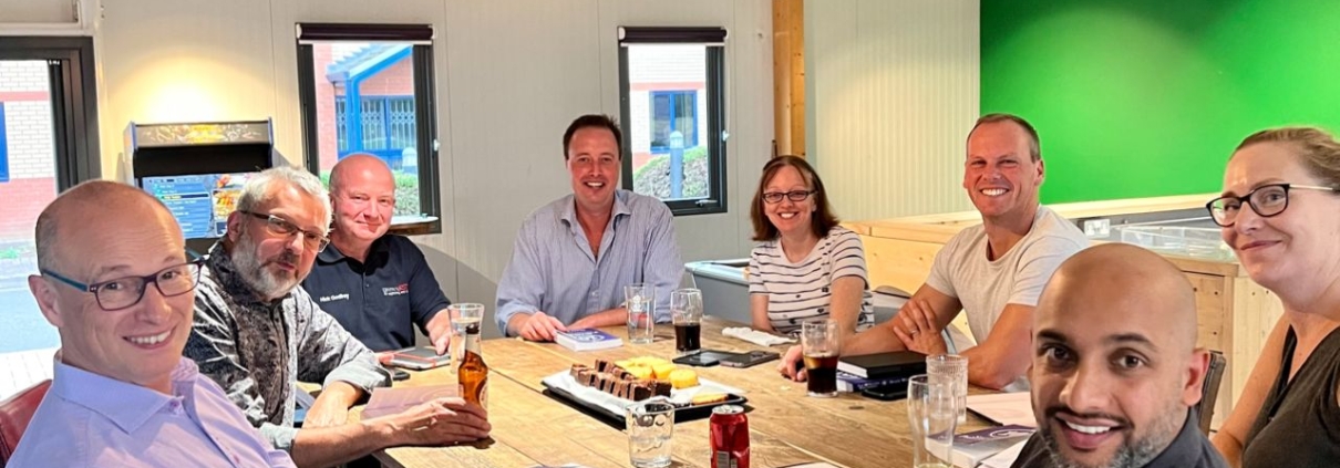 The picture is of ChadStone's Book Club and it shows business owners working together to help each other with hacks for recession-proofing their business