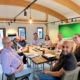 The picture is of ChadStone's Book Club and it shows business owners working together to help each other with hacks for recession-proofing their business