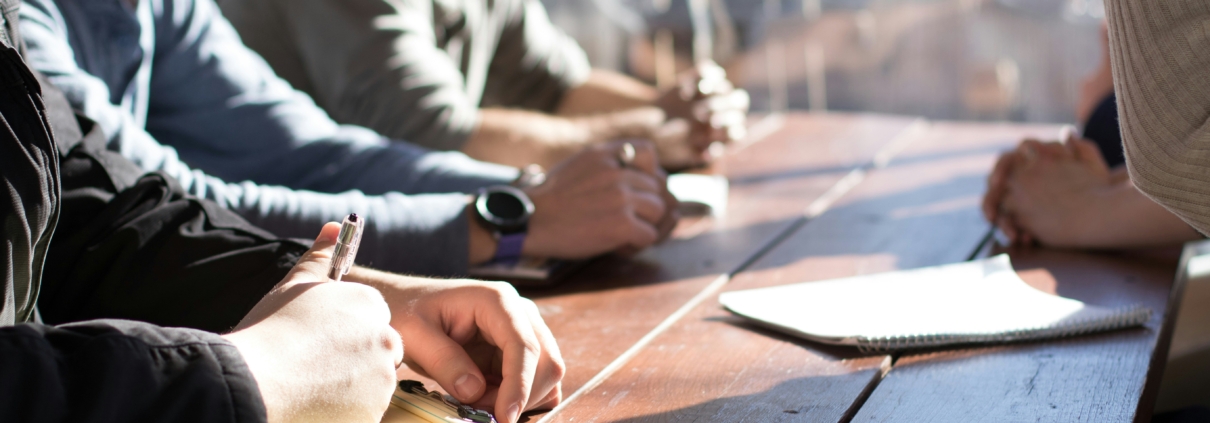This is a picture of business owners and their team having a productive meeting, following the 7 steps in this blog to Propel Your Business Forward in the Final Quarter of the Year