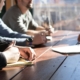 This is a picture of business owners and their team having a productive meeting, following the 7 steps in this blog to Propel Your Business Forward in the Final Quarter of the Year