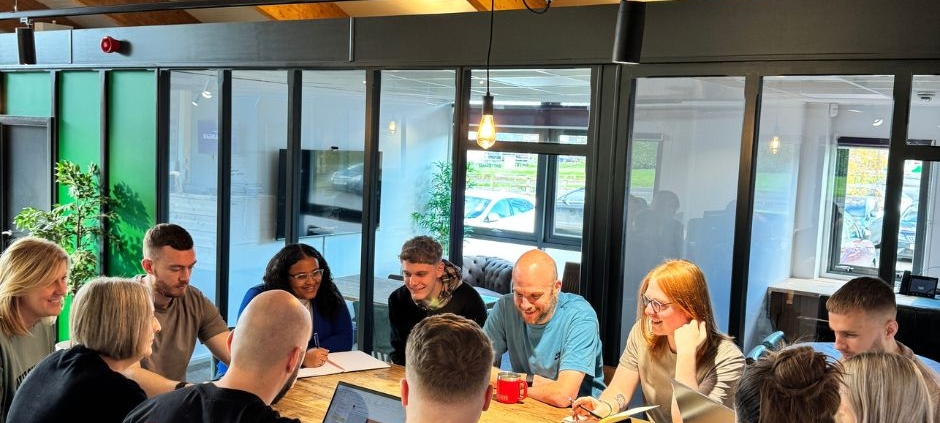 This is a picture of a ChadStone team meeting, showing a February Business Check-In to keep the Momentum Going