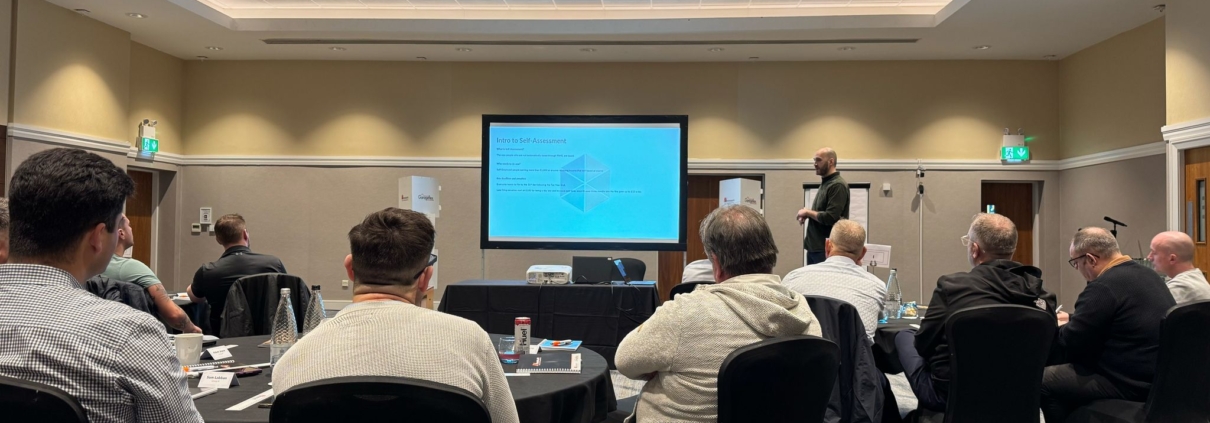 This is a picture of Alex Stone delivering a talk to other business owners on How to Keep Your Business Goals on Track (Without Burning Out)