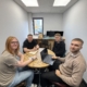 This is a picture of some ChadStone team members around laptops to show How to build a simple business finance system